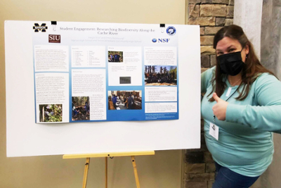 Emily Richbourg standing next to her conference poster titled, "Student Engagement: Researching Biodiversity Along the Cache River"